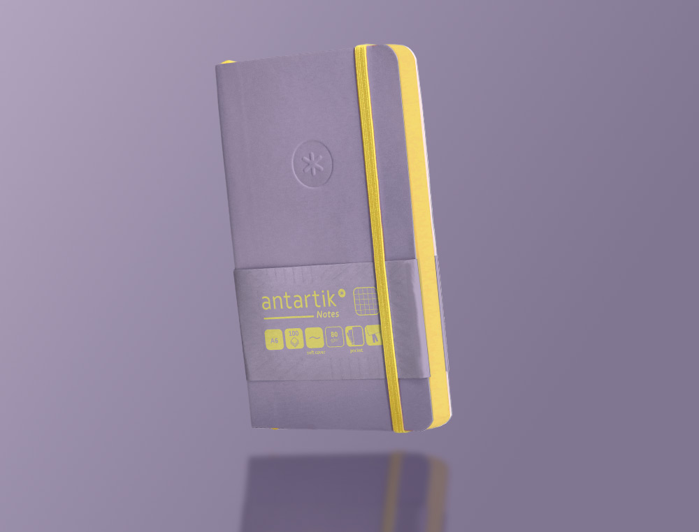 CADERNO COM ELASTICO ANTARTIK NOTES CAPA MOLE A6 QUADRICULADO ROXO E AMARELO 100 FOLHAS 80 GR FSC